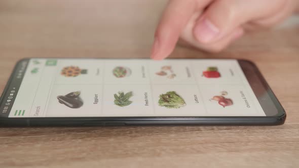 Close Up Of Hand Male Using Smartphone Selects Vegetables In Grocery Online Store, Online Shopping