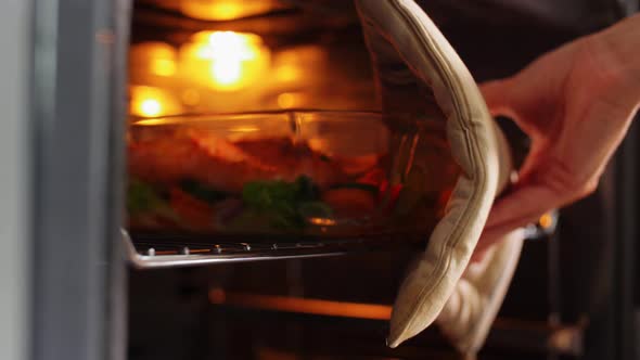 Woman Cooking Food in Oven at Home Kitchen