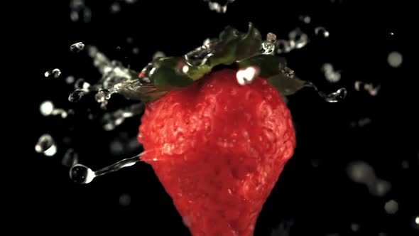 Super Slow Motion on Fresh Rotating Strawberries Drop Drops of Water