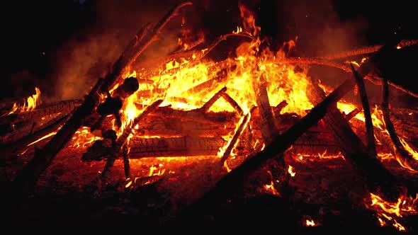 Big Campfire of the Logs Burns at Night in the Forest