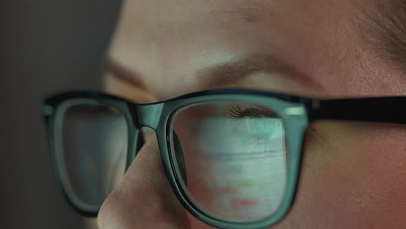 Woman in Glasses Looking on the Monitor and and Working with Charts and Analytics