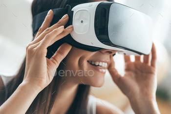 r VR headset and smiling while sitting at home