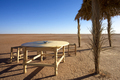 Old wooden chairs and table facing the desert, Morocco - PhotoDune Item for Sale