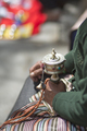 Old woman praying with prayer roll in Lhasa - PhotoDune Item for Sale