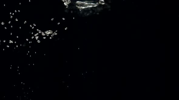 Slow Motion Air Bubbles in Water Rising Up to Surface on Black Background