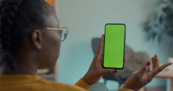 African American Woman Tapping on Green Mock Up Screen of Mobile