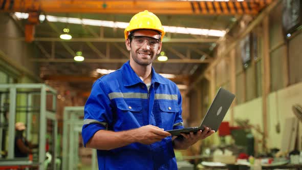 Portrait of Caucasian man industry worker working in factory warehouse.