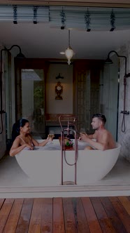 Asian Woman and European Men Relaxing in Bath Tub During Vacation Luxury Holiday