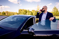 Businessman near a car in a parking lot - PhotoDune Item for Sale