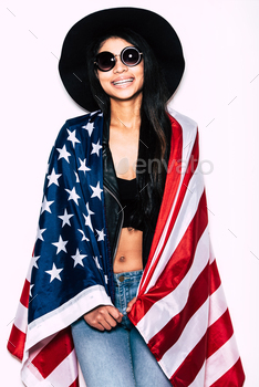 carrying American flag on shoulders and smiling while standing against white background