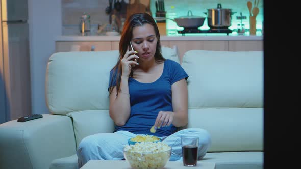 Woman in Pajamas Talking at Phone