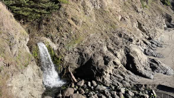 Waterfall at Secret Beach. Oregon Coast travel and tourist destination.