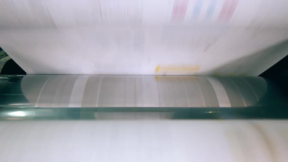 Paper Is Moving Through Typography Rolling Mechanism. Paper Production Machine.