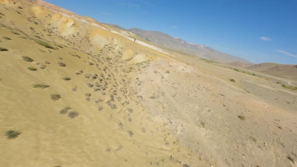 FPV Sports Drone Shot Destruction Mountain Dry Cracked Texture Landscape Follow Male Photographer