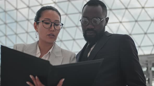 Close Up of Business Colleagues Discussing Documents