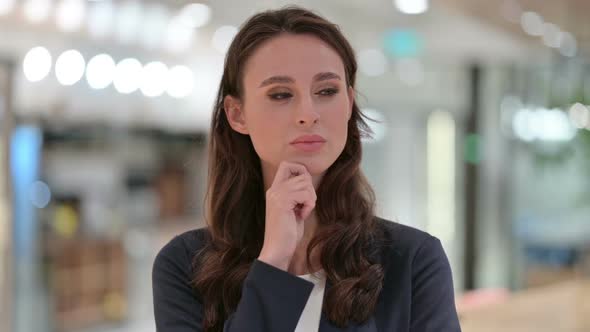 Portrait of Young Businesswoman Thinking About Something