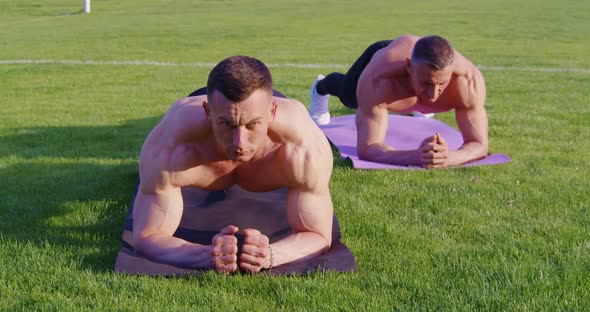 Sporty Shirtless Guys Doing Exercises for Abs on Fresh Air