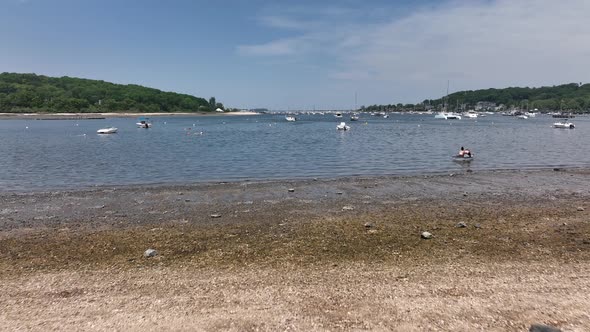 A low angle view from Scudder Park heading to Northport Marina on Long island with anchored boats. I