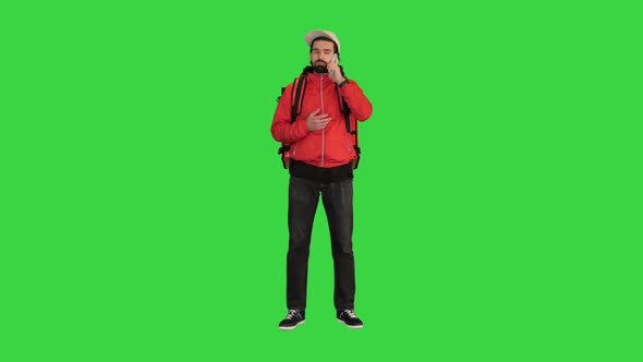Courier Making a Call Searching for Delivery Address on a Green Screen Chroma Key