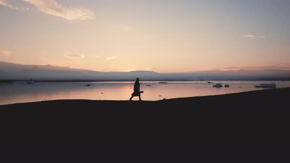 Silhouette Of Man Walking Through Icelandic Landscape