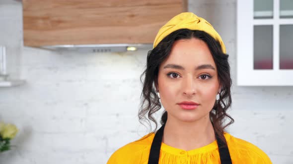 Close Up Serious Housewife Turns Head Looking Camera in Home Modern Kitchen