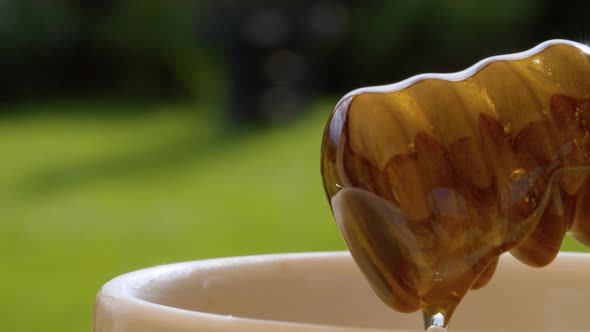 Honey pouring from honey spoon