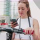 Slow motion woman using smartphone scaning qr code unlocking kick scooter - VideoHive Item for Sale