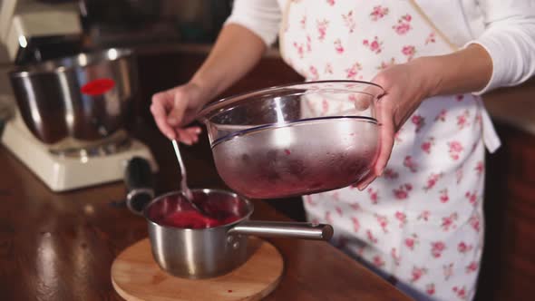 Woman Adds Some Berries in a Mix