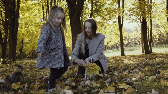 Happy Woman with Her Little Son and Daughter Having Rest in Park