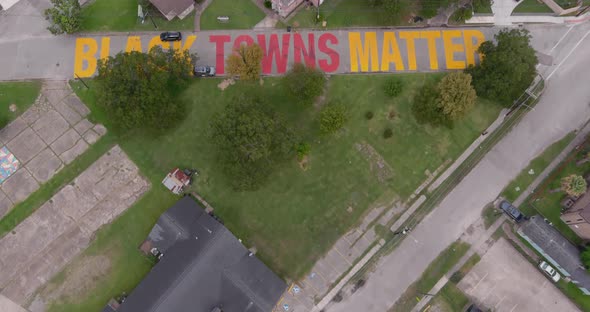 Bird eye view of a large "Black Towns Matter" sign painted on street in Houston Historical independe