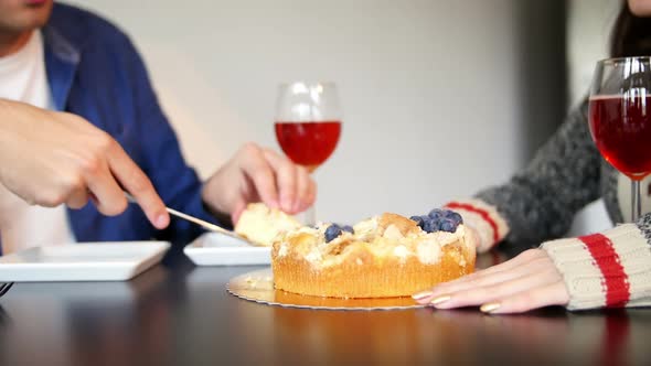 Mid-section of couple cutting cake