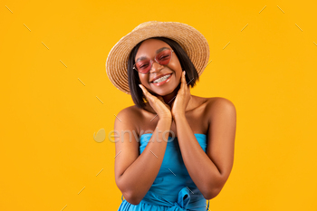 Portrait of gorgeous black woman in casual summer outfit touching her face and smiling at camera on / Photodune, Misc