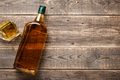 Bottle and glass of whiskey on wooden boards - PhotoDune Item for Sale