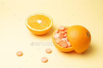  of an orange on a yellow background, immune booster concept, close up.