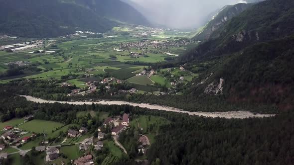 Aerial reveal type shot of the Sugana Valley in Trentino, Italy with drone static on a very sunny an