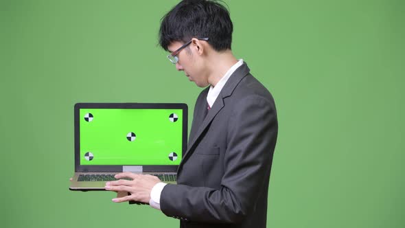 Young Asian Businessman Showing Laptop To Camera
