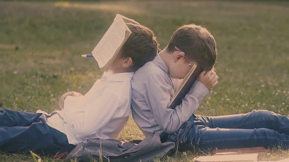 Tired Boys in Shirts and Jeans Sleep with Books in Hands