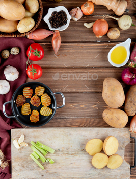 top view of vegetables as tomato, potato, garlic with potato chips, butter, black pepper on wooden / Photodune, Misc