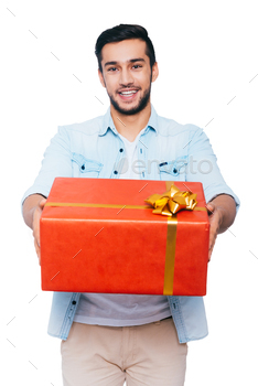  out red gift box and smiling while standing against white background