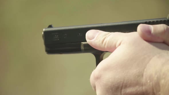 Close-up Shot of a Pistol. Slow Motion.