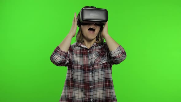 Young Girl Using VR App Helmet To Play Simulation Game. Woman Watching Virtual Reality 3d Video
