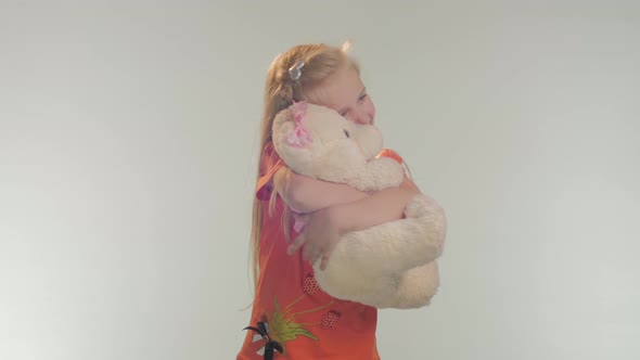 Little girl hugging her teddy bear