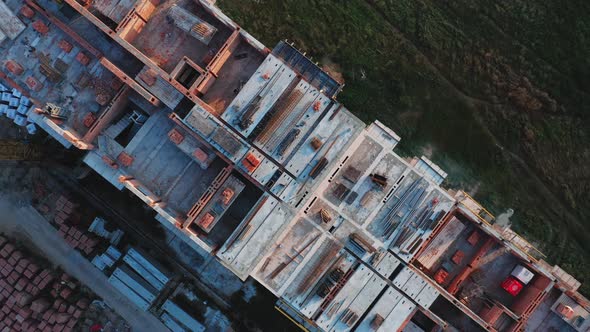 Aerial Rotating Top View of the Construction of a Residential Building at Sunset on a Summer Day