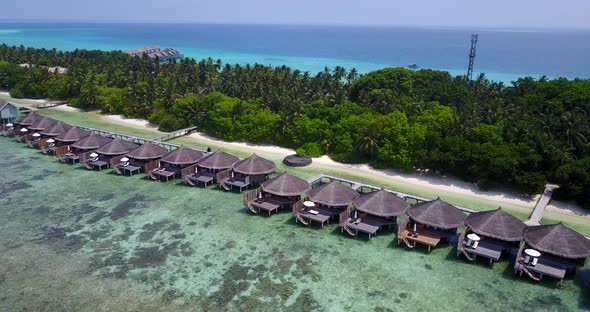 Daytime fly over clean view of a white sandy paradise beach and aqua turquoise water background 