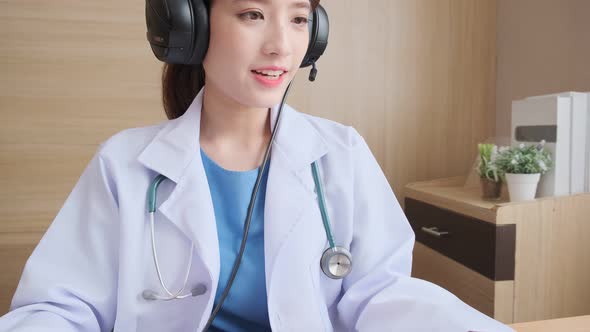 Young attractive Asian female doctor diagnosis talking and looking to camera