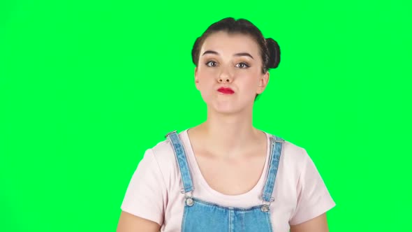 Young Woman Stands Waiting with Boredom on Green Screen. Slow Motion