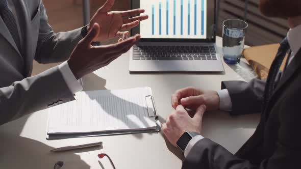 High Angle of Two Businessmen Shaking Hands and Discussing Contract