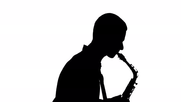 Close Up of Dark Silhouette of Saxophonist Playing His Musical Instrument on White Background