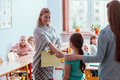 Young teacher and student in the classroom during the first maths lesson - PhotoDune Item for Sale