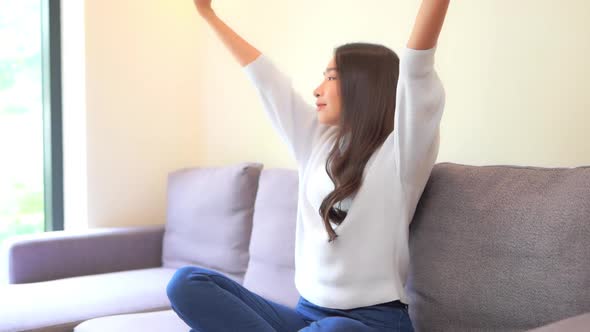 Asian woman sit on sofa and relax